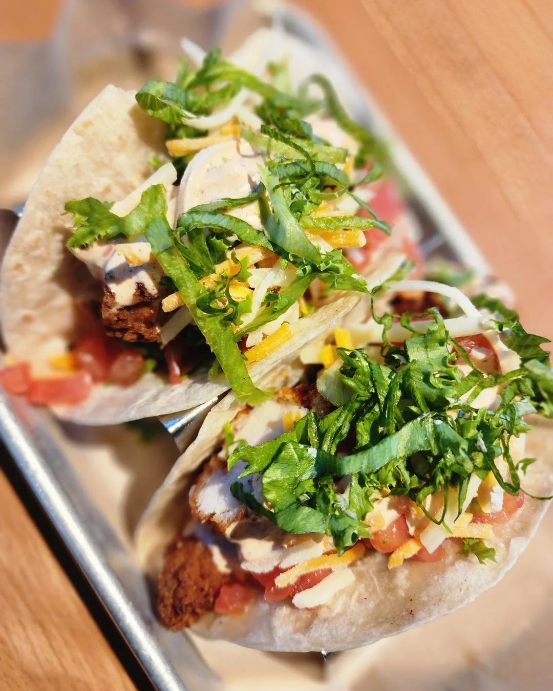 🔥 You asked&hellip; we listened!
Our zesty chicken tender tacos are here and they do NOT disappoint 🌮
Crispy chicken, fresh lettuce, tomato, shredded cheese, and our house-made guajillo ranch &mdash; all wrapped up and ready to disappear fast.
Come