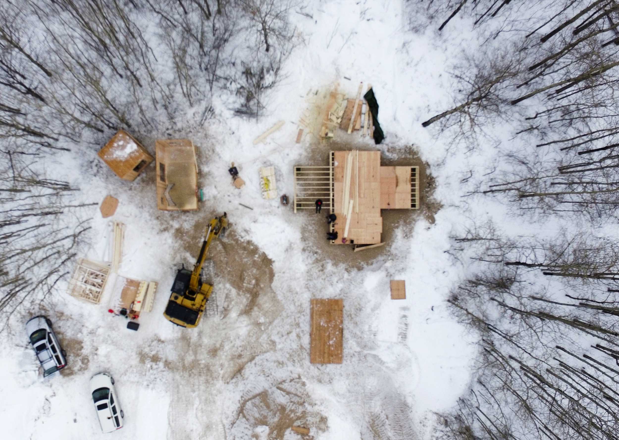 Opaskwayak Cree Nation, Umpherville Road development. In this aerial view of the lot under development, the EDITdx House is being reassembled in the upper left of the image and the floor system for the OCN trainee-designed house is under construction on the upper right.