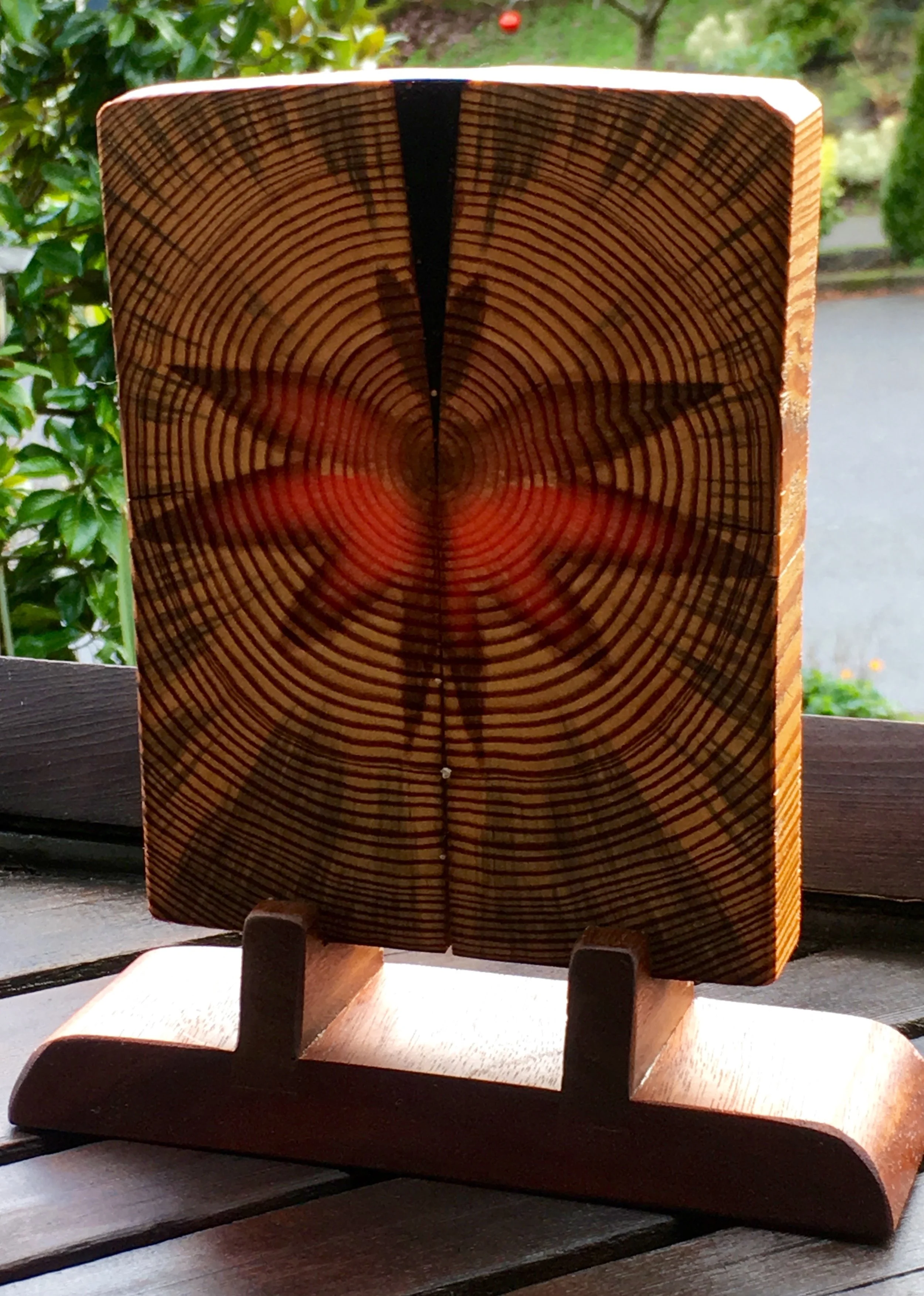 Sap Heart Art Piece with Reclaimed Koa Stand, lit from behind.