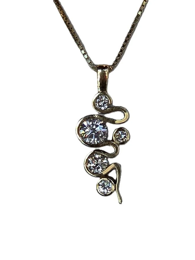 Custom pendant in 14 karat yellow gold, 5 natural diamonds, created from a family heirloom.
