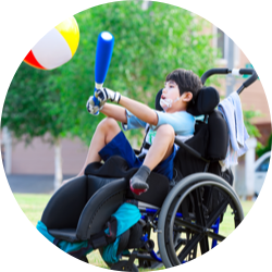 Boy in wheelchair playing ball