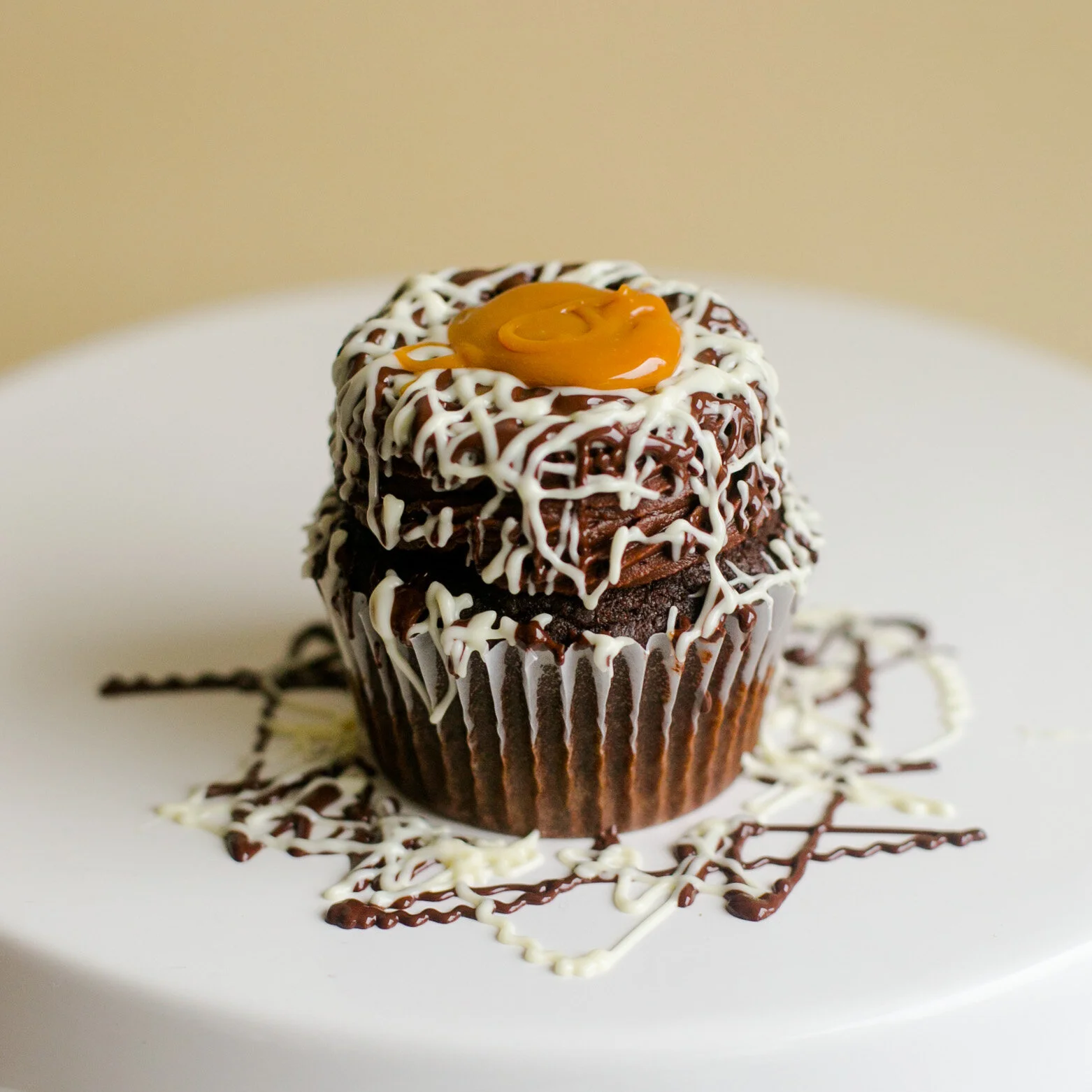 DOUBLE CHOCOLATE CARAMEL Rich chocolate cake filled with caramel. Topped with smooth chocolate buttercream and drizzled with dark and white chocolate drizzle. Finished off with extra caramel.