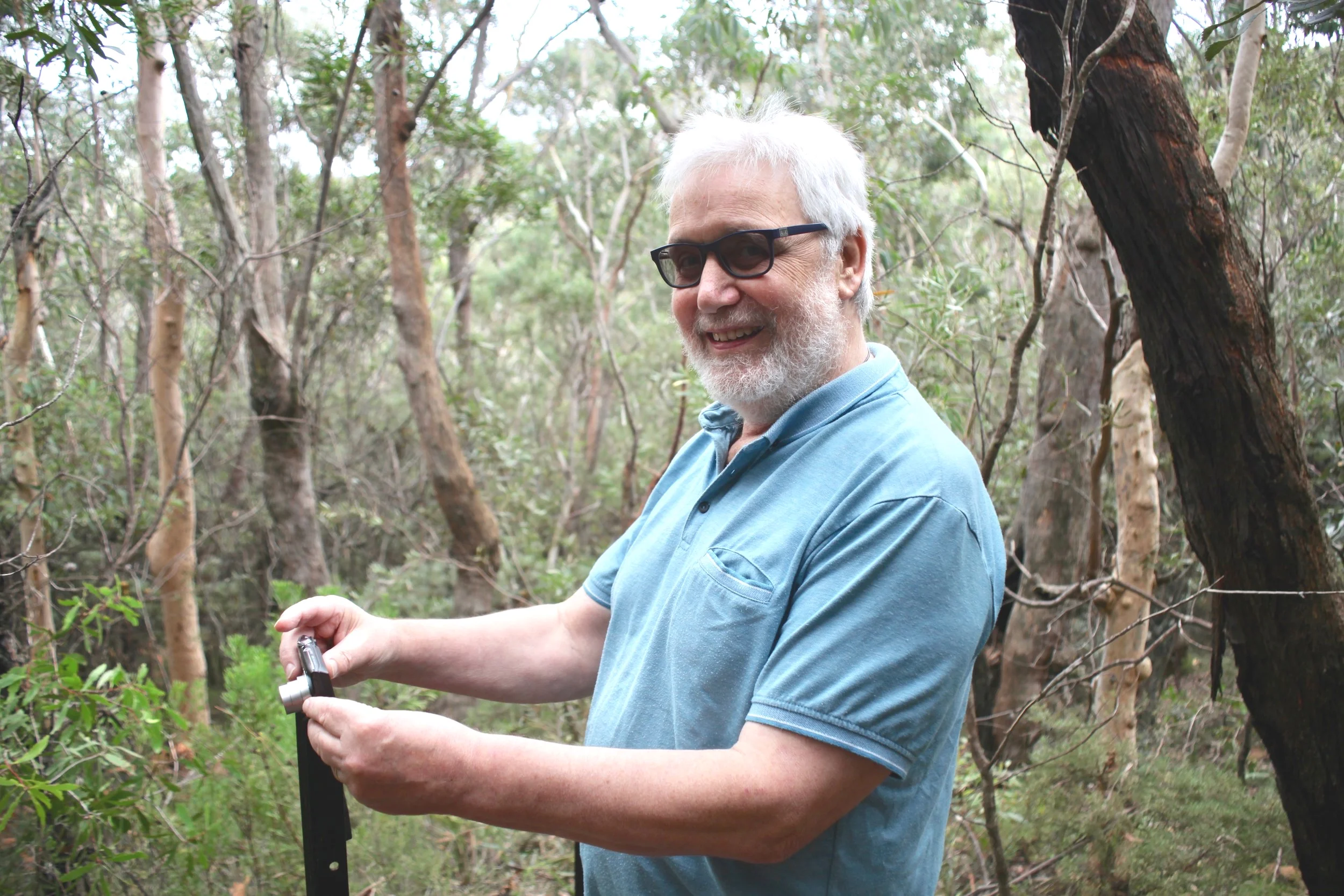 Frank Furlong, a volunteer citizen scientist records data near the Conservation Hut in Wentworth Falls.