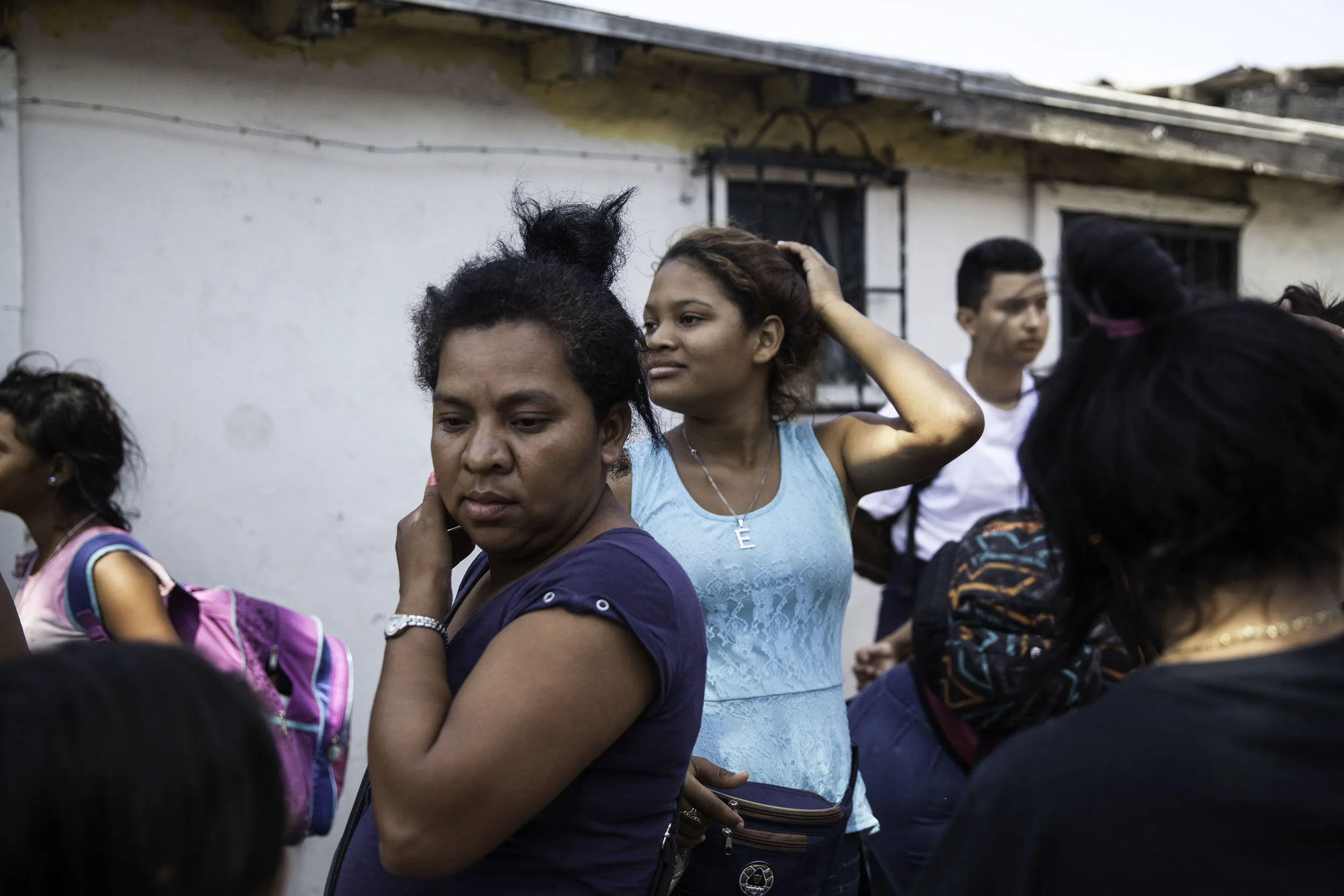 After the third bus arrives in Tijuana, MX, people stood around for a few minutes taking a moment and gathered their belongings on April 25, 2018.