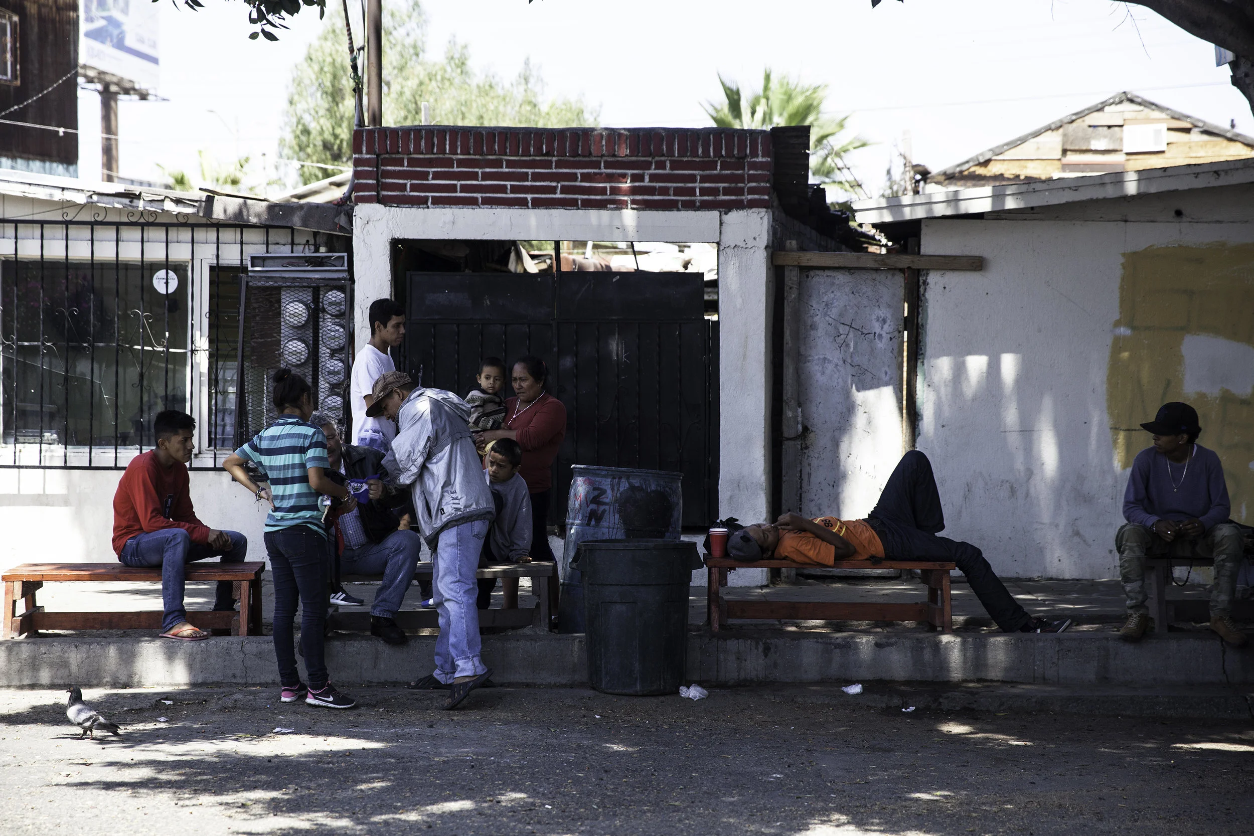 People had a few days of downtime before the legal workshops began by attorneys who have volunteered from the U.S. and Mexico to help guide them on what to possibly expect before trying to seek asylum in the United States. Migrants stand across the street from Juventud 2000 shelter in Tijuana, MX, on April 26, 2018.