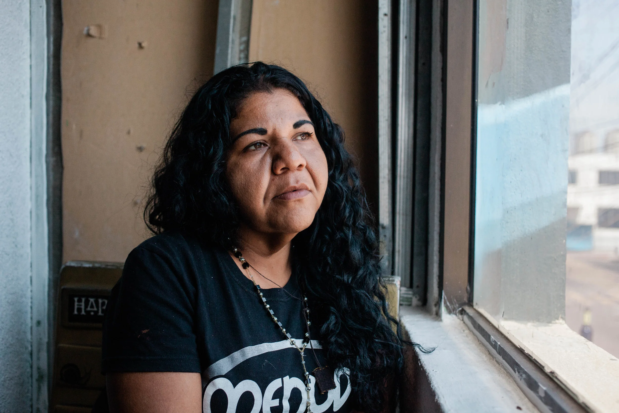 Argelia sits in a cafe in Tijuana, MX, on August 15, 2018. She traveled with the migrant caravan that started at the Guatemala-Mexico border in late March. She was recently arrested by the Tijuana police. Born in Guatemala but grew up in Honduras. While in Tijuana she was walking with two male friends and a guy who claimed to be MS-13 attempted to rob them. When the police arrived they arrested everyone. Argelia refused to be strip-searched and was put in a cold cell for 12 hours. Police threatened that she would be deported but when the National Institute of Immigration realized that she has a humanitarian visa they released her. Argelia says the Tijuana police often takes them for no reason.