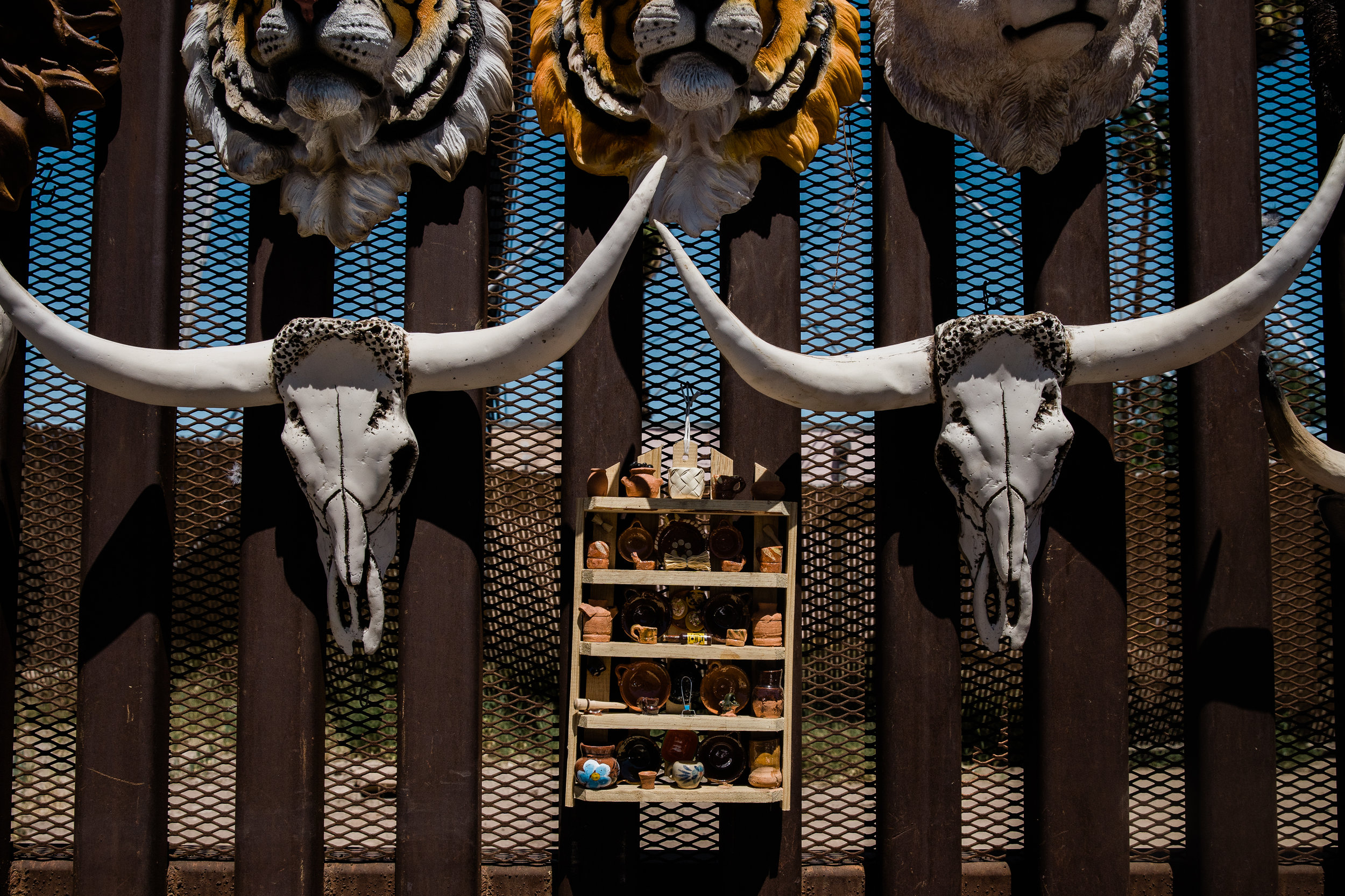 Souvenirs are displayed on the border fence that divides the US and Mexico in Mexicali, Mexico on April 4, 2019.