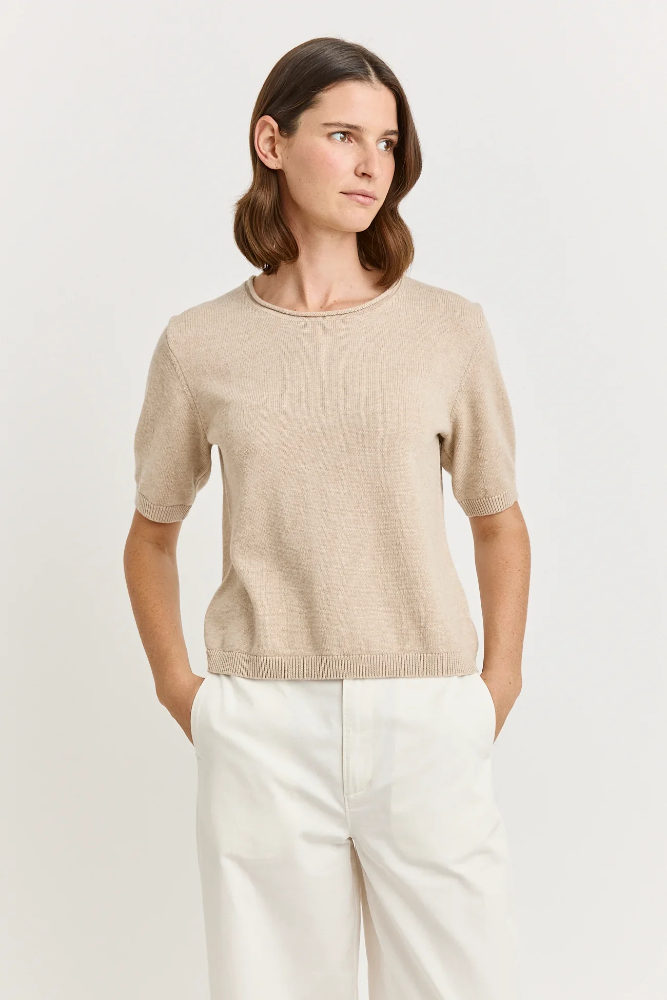 Woman wearing the Jute (light beige) colour variant of the Toorallie Links Cap Sleeve Top made from Organic Cotton and Merino