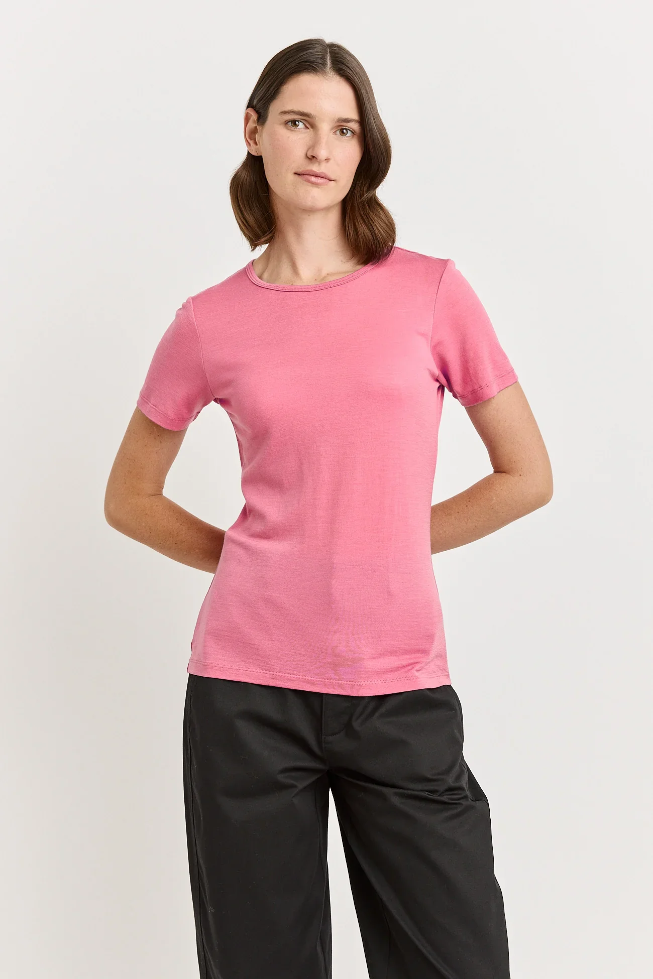 Woman wearing a Flamingo (Pink) coloured Toorallie Short Sleeve Crew Tee, made from Merino Wool)