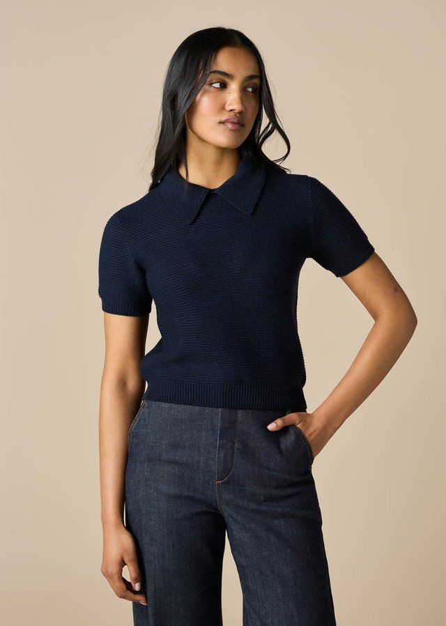 Woman wearing the Midnight colour variant in the uimi knitwear Pearl Tee made from 100% Merino wool
