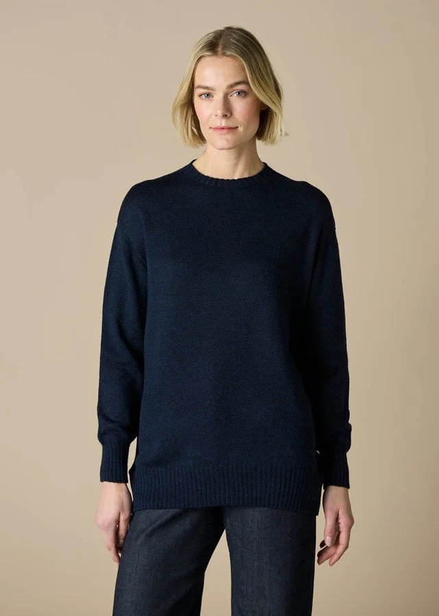 Woman wearing the Midnight (dark blue) colour variant in the Olive Jumper from uimi knitwear.