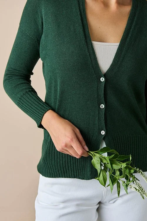 Closeup shot of the Basil (dark green) colour variant in the uimi knitwear Edith Cardigan made from Egyptian Cotton