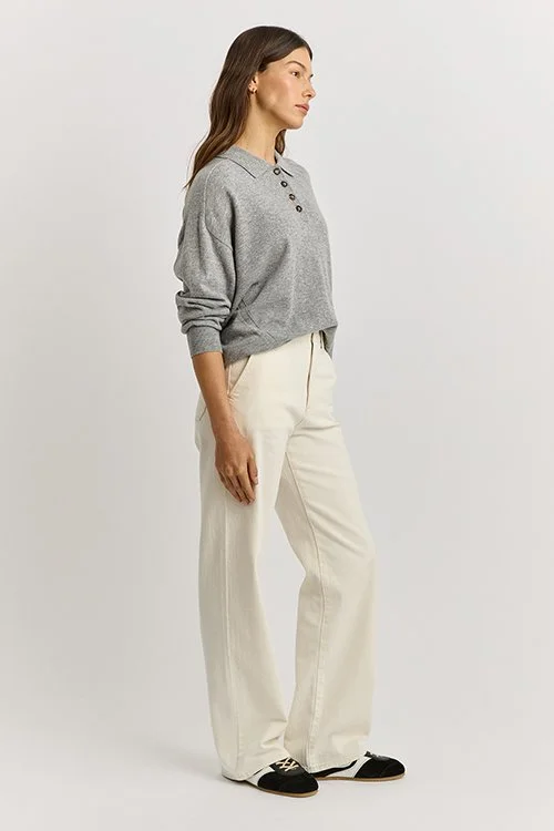 Full view of a woman wearing the light ash grey variant of the Fine Jersey Polo Pullover from Toorallie