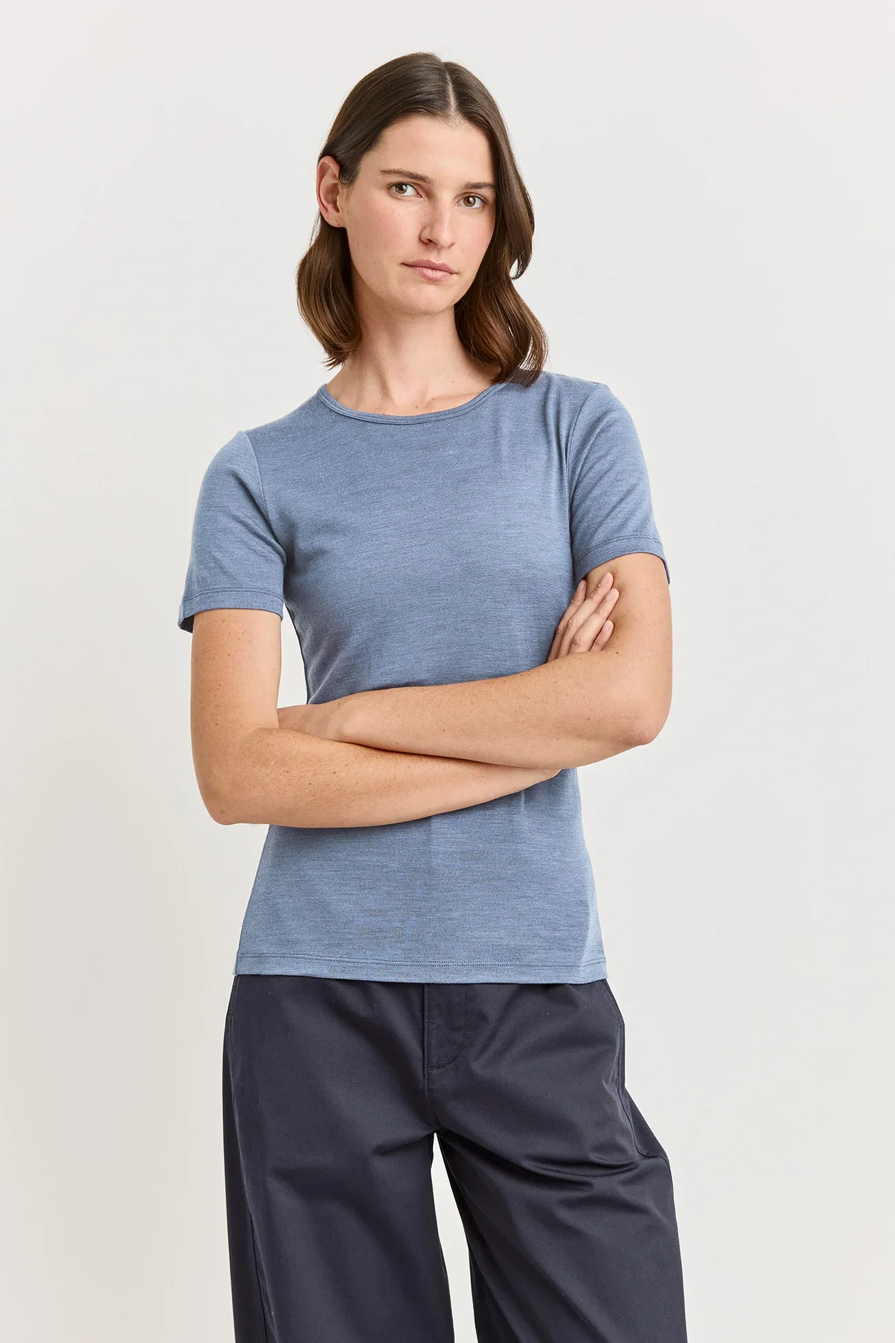 Woman wearing a Mist (pale blue) coloured Toorallie Short Sleeve Crew Tee, made from Merino Wool)