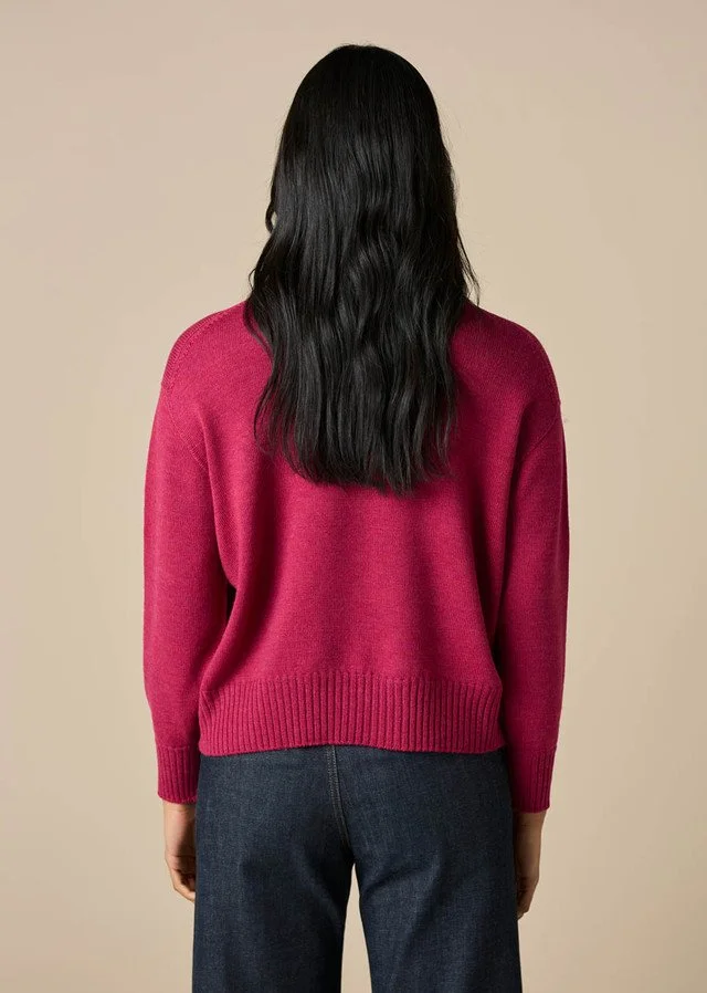 Back view of a woman wearing the Magenta colour of the Matilda Jumper from uimi knitwear.