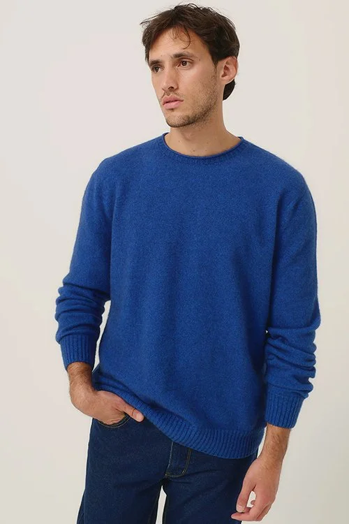 Man wearing a Merinomink Classic Crew Sweater made from Merino wool and Possum Fibre in the dusty blue colour variant.