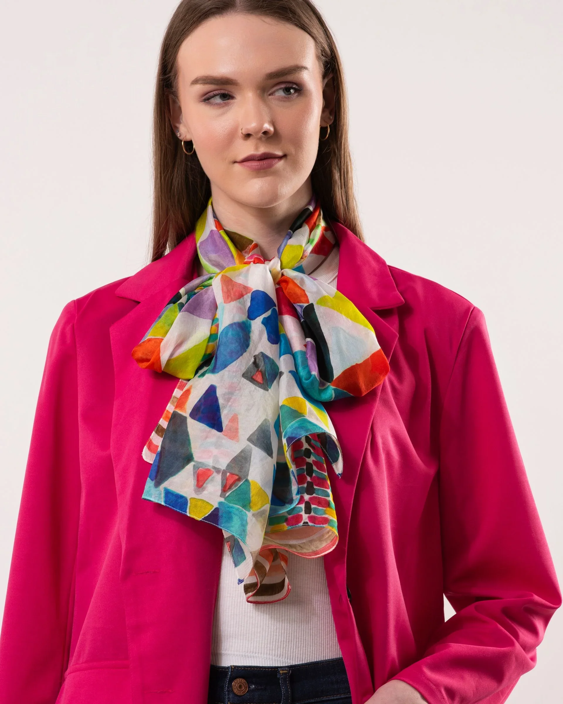 Woman wearing the Multi colourway variant of the Tessera silk scarf from DLUX