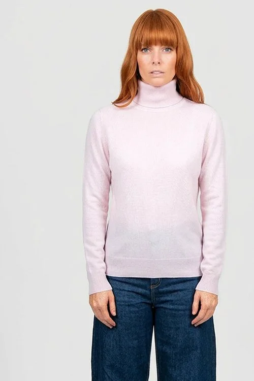 Woman wearing the Pale Pink colour variant of the Bridge & Lord roll neck pullover