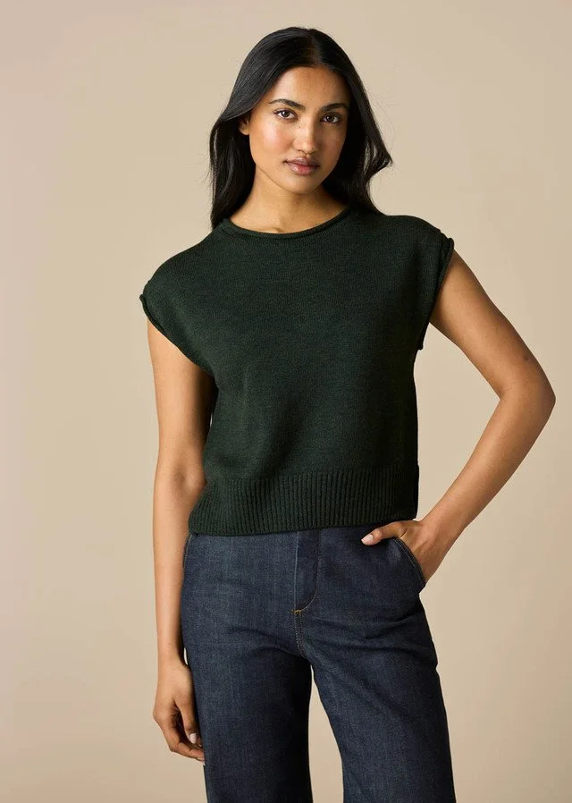 Woman wearing the basil green version of the uimi knitwear | Agnes Jersey Vest made from 100% Merino wool.