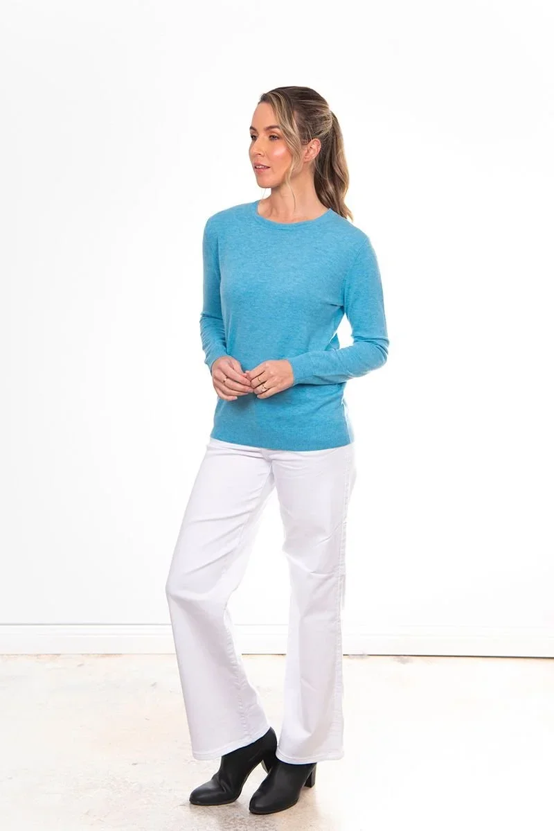 Woman wearing the Frosted Blue colour variant of the Bridge & Lord crew neck jumper