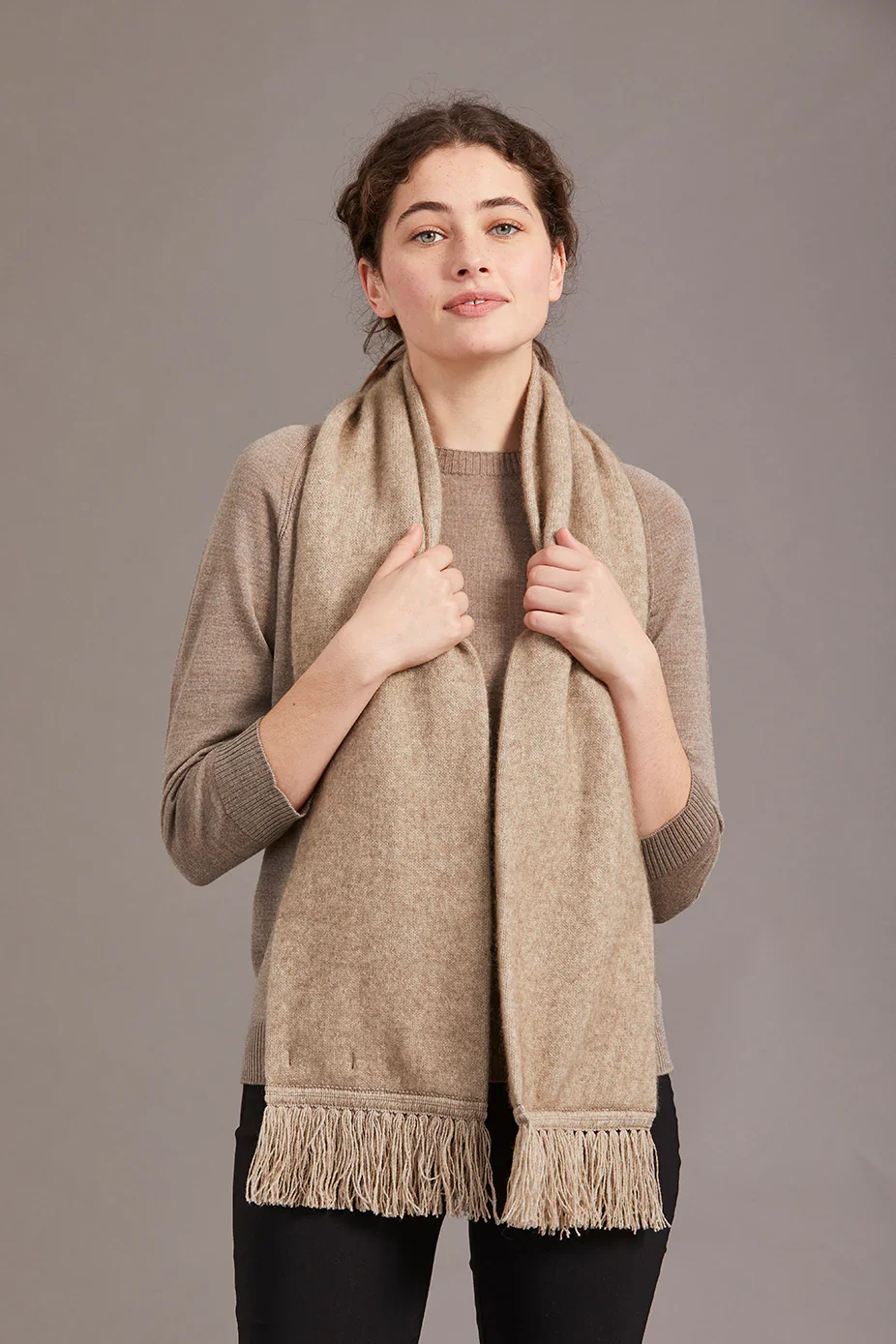 Woman wearing the mocha (beige) colour variant colour of the Tubular Scarf from McDonald Textiles
