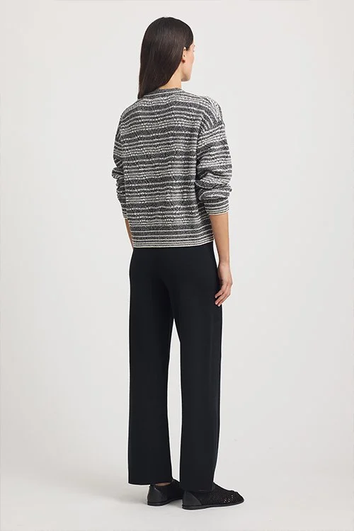 Back view of a woman wearing the Diamond Cable Cardigan from Toorallie made from 100% Merino Lambswool