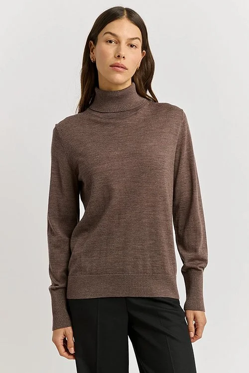 Woman wearing the mocha colour variant of the Toorallie Extra Fine Turtle Neck Jumper
