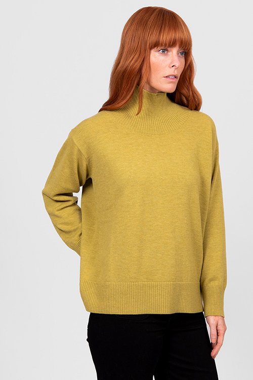 Woman wearing the Citrine colour variant in the Bridge & Lord | Boxy Rib Funnel Neck Pullover made from Merino wool and cashmere