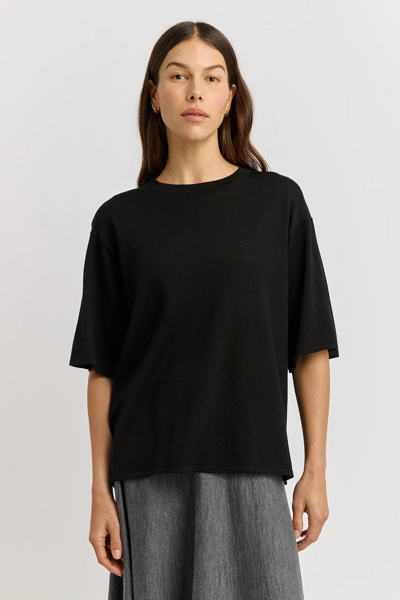 Woman wearing the black colour variant of the Extra Fine Relaxed Knit Tee  made from 100% Merino Wool by Toorallie