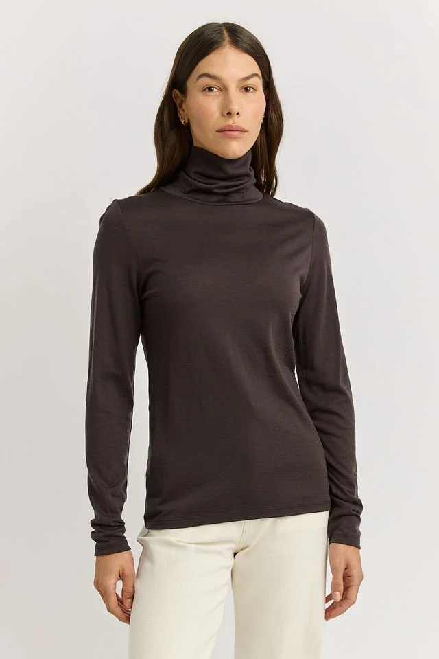 Woman wearing the date brown colour variant of the  Toorallie  Turtle Neck Tee made from 100% Merino Wool)