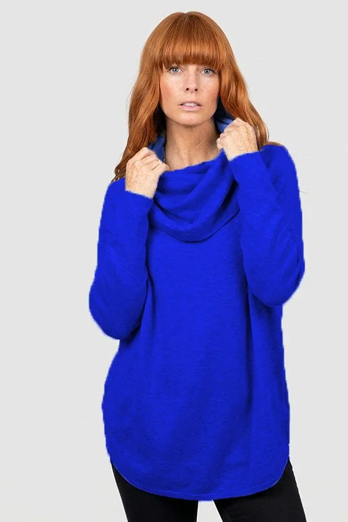 Woman wearing the Cobalt Blue colour variant of the Bridge & Lord — Essential Curved Hem Cowl Neck Jumper made from Merino wool & Cashmere.
