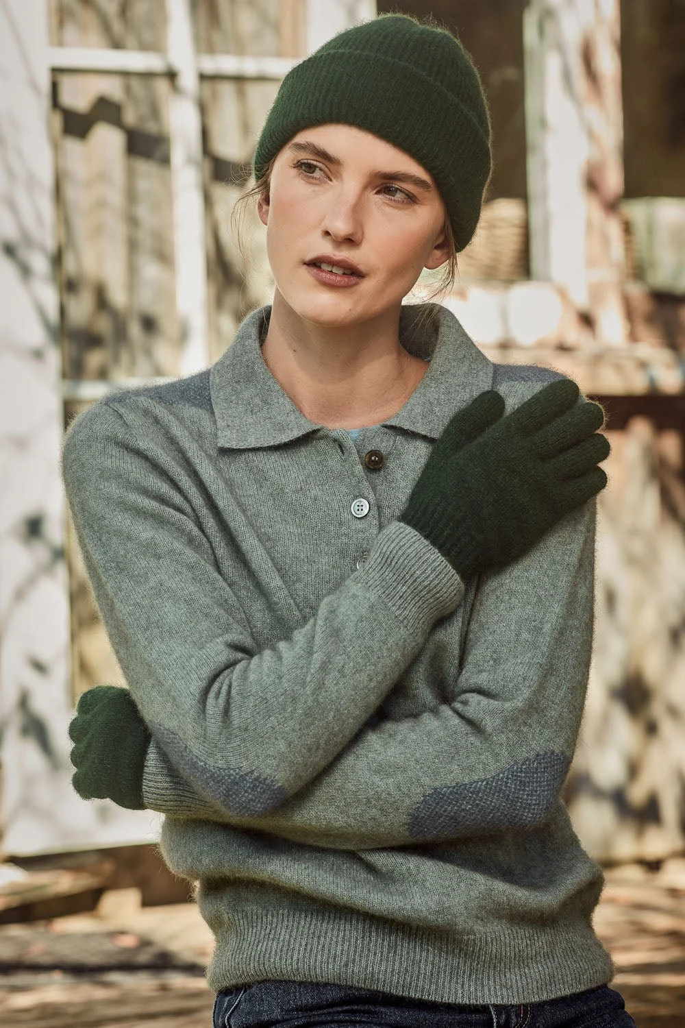 Woman wearing the Forest green colour variant of the Fine Rib Hat from McDonald NZ
