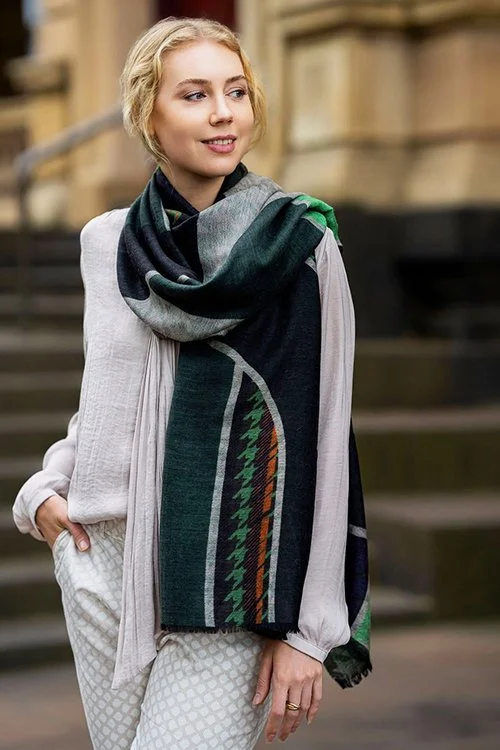 Woman wearing the khaki colour variant of the houndstooth patterned Agnes Scarf made from 100% Merino wool.