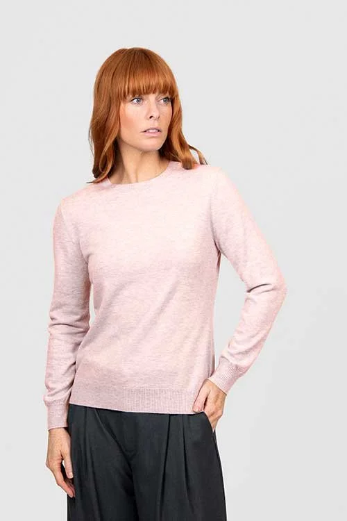 Woman wearing the pale pink colour variant of the Bridge & Lord crew neck jumper