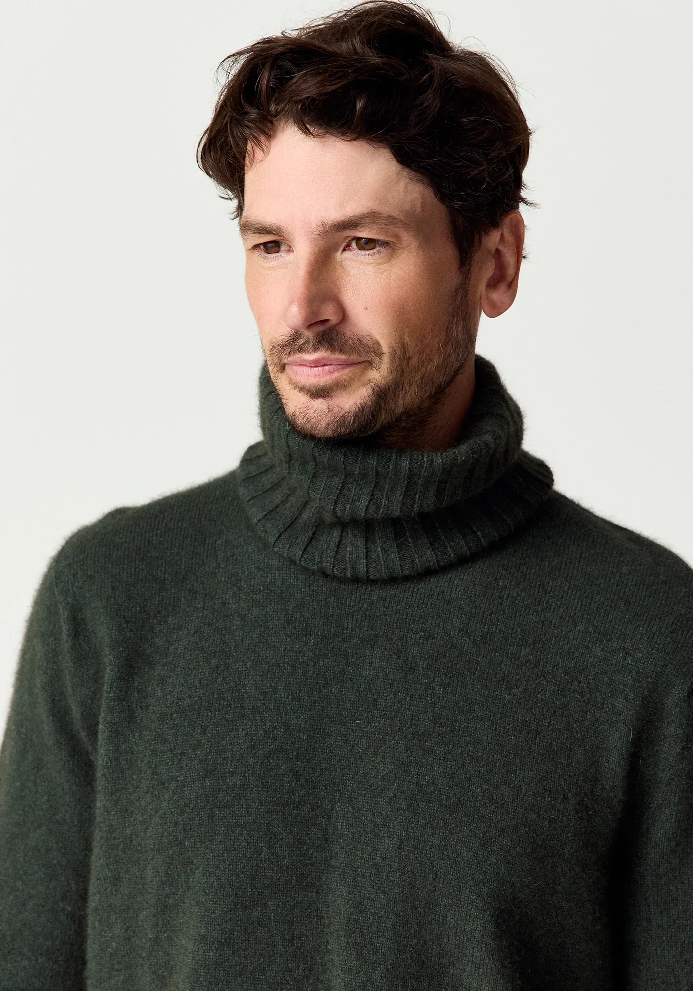 Man wearing the Wilderness (dark green) colour variant of the Merinomink™ Essential Snood made from Merino Wool, Possum Fur, and Silk