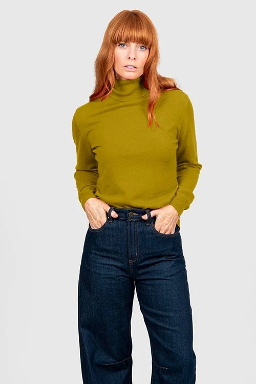 Woman wearing the Citrine colour variant of the Bridge & Lord roll neck pullover
