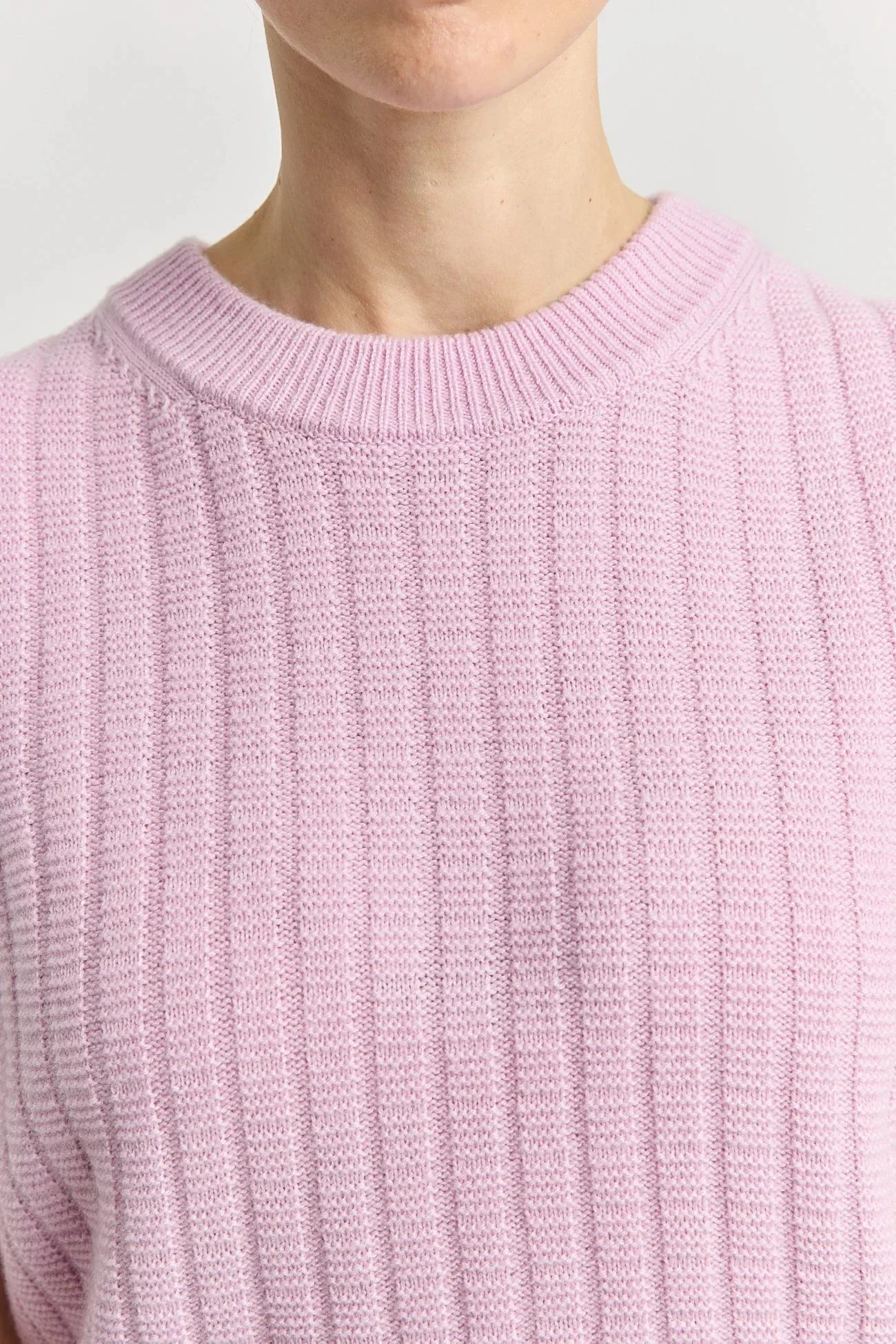 Closeup of the powder pink Grid Knit lambswool merino vest for women