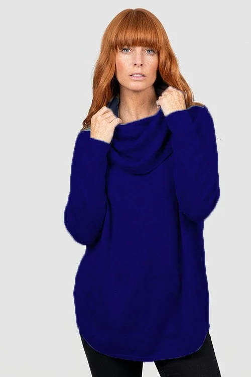 Woman wearing the Carbon Blue colour variant of the Bridge & Lord — Essential Curved Hem Cowl Neck Jumper made from Merino wool & Cashmere.