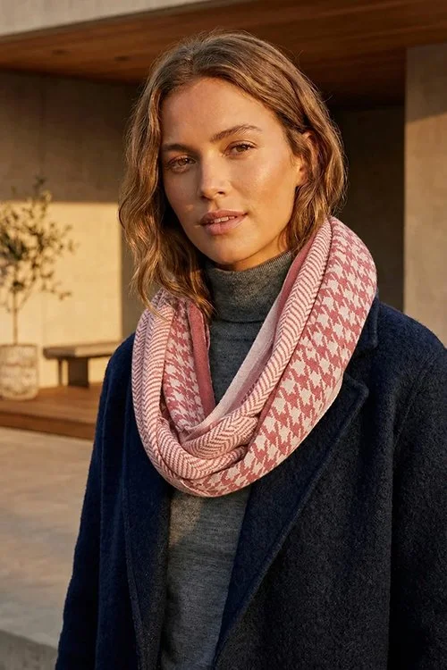 Pink and white colour variant of the Bone and Tooth Loop Scarf from DLUX knitted from 100% cotton.