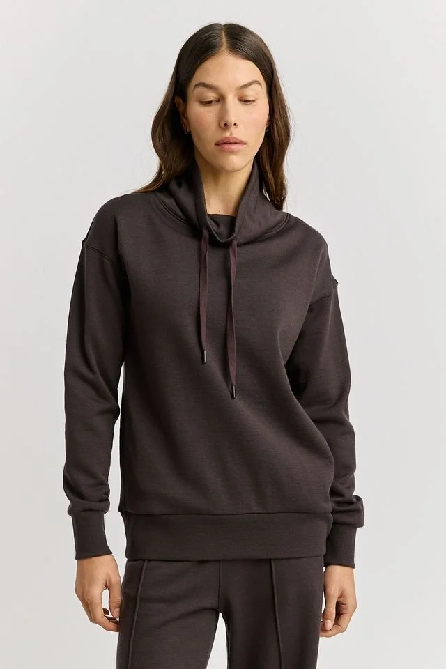 Woman wearing the Toorallie | Lounge Funnel Neck Sweater (Merino wool + Cotton), Date (brown) colour variant