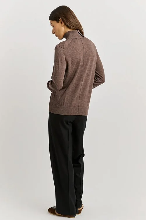 Back view of a woman wearing the mocha colour variant of the Toorallie Extra Fine Turtle Neck Jumper