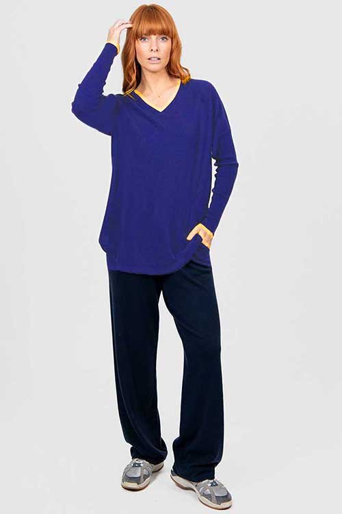 Woman wearing the Bridge & Lord | Queen Vee Curved Hem Pullover made from Merino wool and cashmere in the Cobalt Blue colour variant