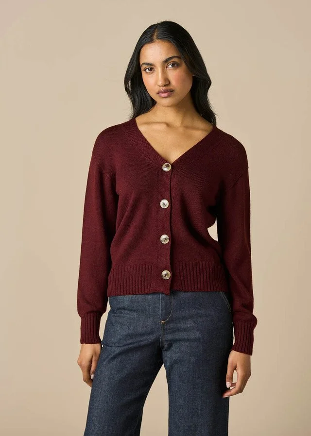 Woman wearing the merlot (dark red) colour variant of the uimi knitwear | Agnes Jersey V-neck Cardigan made from 100% Merino wool.