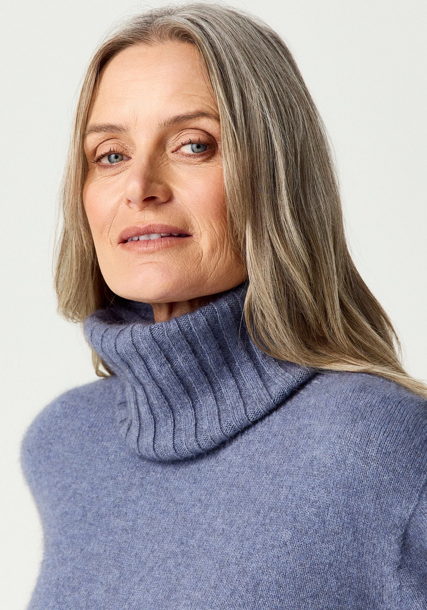 Woman wearing the Waterfall (lilac) colour variant of the Merinomink™ Essential Snood made from Merino Wool, Possum Fur, and Silk