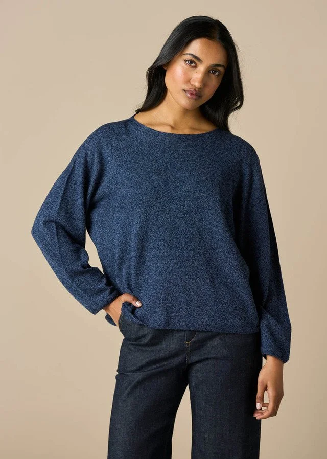 Woman wearing a uimi knitwear | Phoebe Jersey Top (100% Merino wool) in the denim blue colour variant.