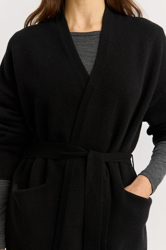 Closeup of a woman wearing the black colour variant of the Toorallie | Relaxed Knit Cardigan  made from 100% Merino lambswool