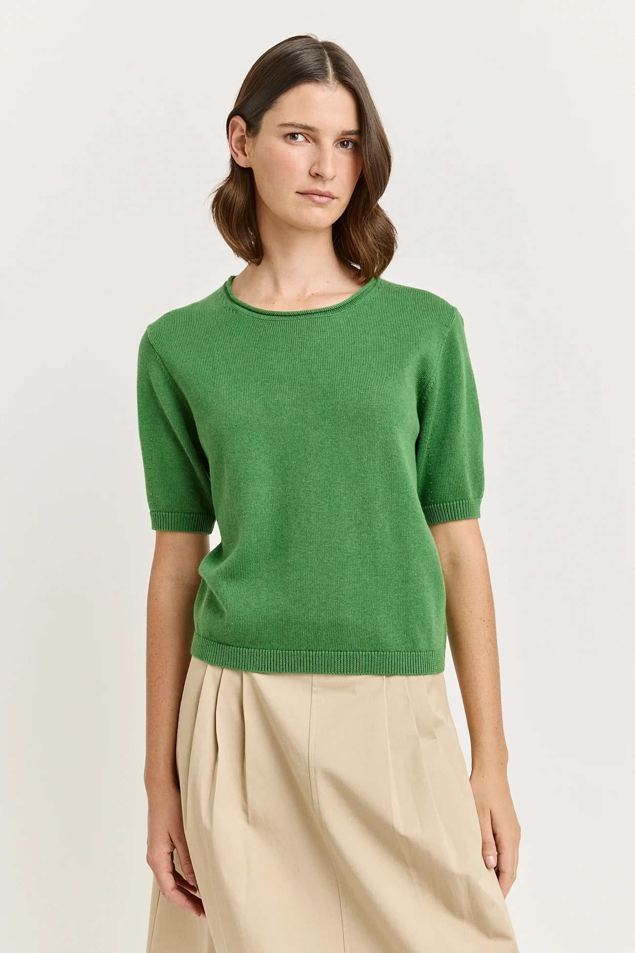 Woman wearing the Spring (green) colour variant of the Toorallie Links Cap Sleeve Top made from Organic Cotton and Merino