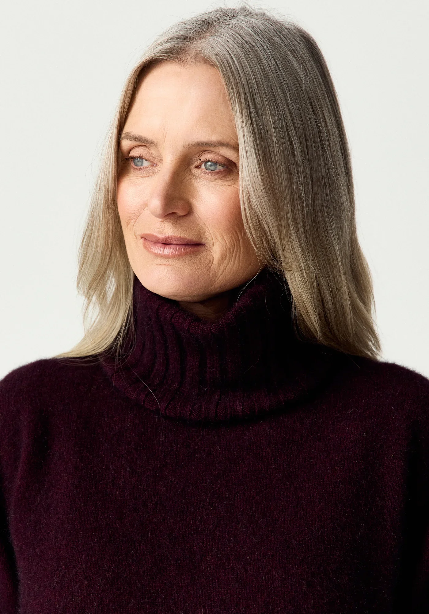 Woman wearing the Beetroot (dark red) colour variant of the Merinomink™ Essential Snood made from Merino Wool, Possum Fur, and Silk
