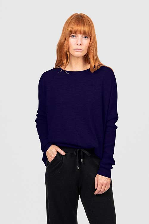 Woman wearing the Carbon Blue colour variant of the Bridge & Lord — Queen Crew-Neck Jumper made from Merino wool & Cashmere from Bridge & Lord