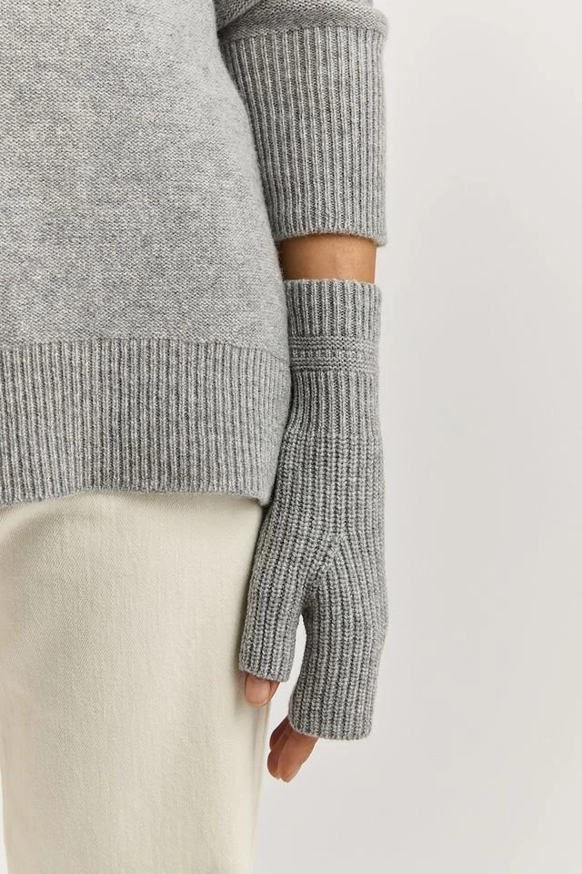 Woman wearing the Light Ash colour variant of the Toorallie open mitten.